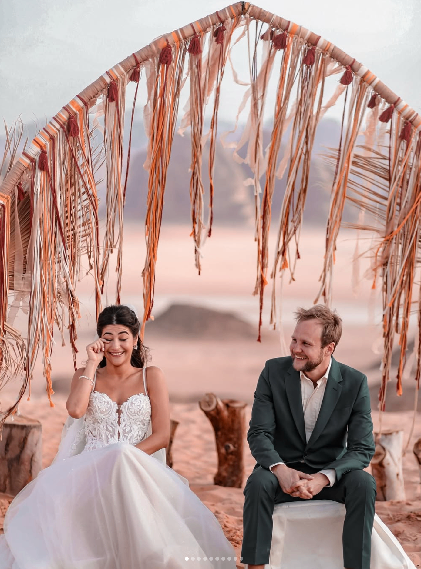 Bride and groom under Bedouin arch